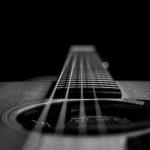 grayscale photo of acoustic guitar